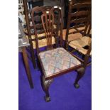 A mahogany dining chair with ball and claw feet