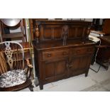 A dark stained Ercol style court cupboard, width approx. 126cm