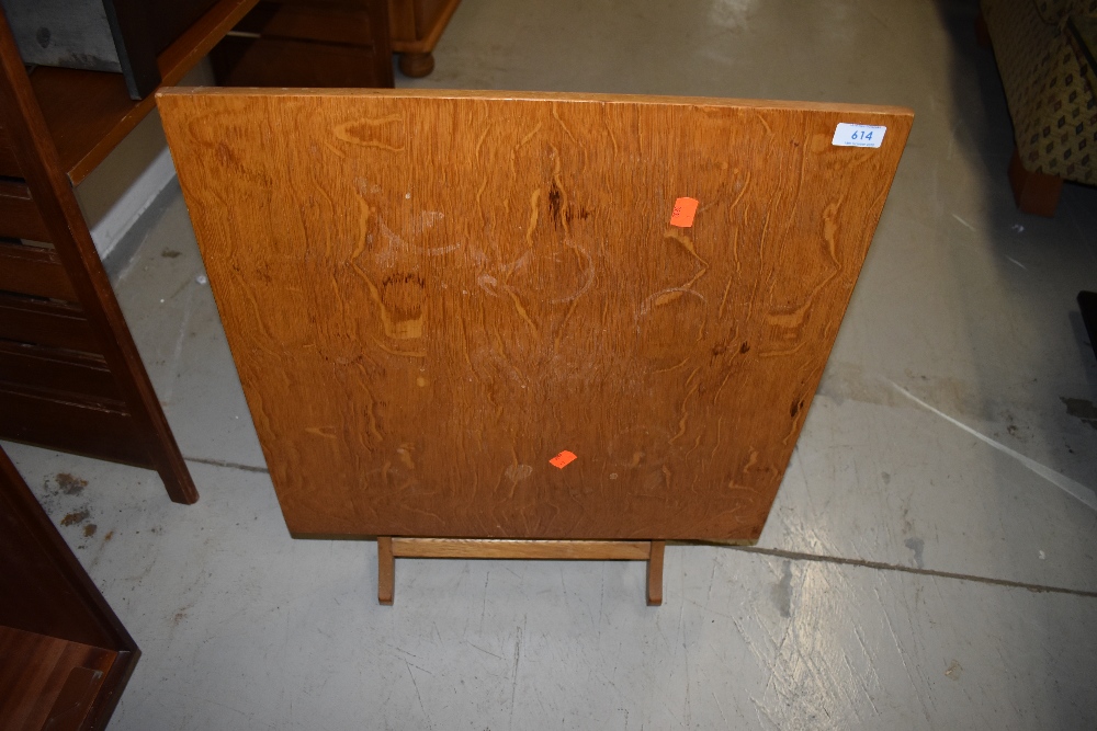 A vintage golden oak folding table