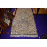 a small fire side rug in pastel colours