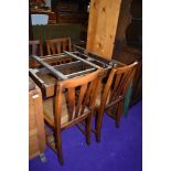 A mid 20th Century draw lead table and four chairs