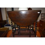 A traditional dark oak twist gateleg table, width approx. 70cm