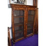 A flame veneered double fronted book case