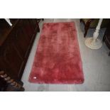 A vintage pink rug, deep shag pile, approx. 150cm x 80cm