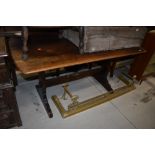 A traditional dark stained Ercol style refectory style table