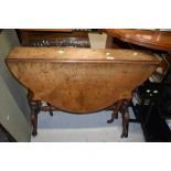 A Victorian walnut sutherland table having shaped top , turned frame , shaped legs, on pot