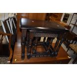 A nest of three priory style tables, dark stained