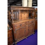 An oak court cupboard with traditional carvings width approx 120cm