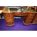 A traditional serpentine fronted mahogany desk by Reprodux Bevan Funnell