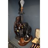 A table lamp hand carved as an African elephant standing at 60cm