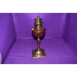 an antique oil burning lamp having copper well with brass fitments by WAS Benson