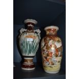 Two Japanese vase one having twin handle design and similar highly decorated with Samurai