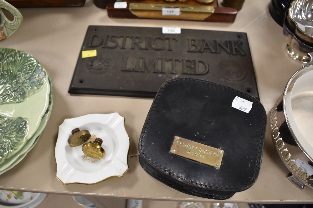 An antique cast sign 'district bank limited' two brass stamps and similar banking related