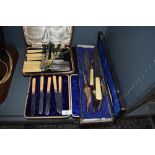 A selection of cutlery table and flatwares including boxed fruit knives and horn handle carver set