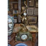 A continental marble effect mantle clock having gilded spelter cherub decoration.