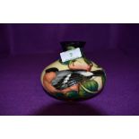 A modern Moorcroft (2003) Squat Vase having Bullfinch and Fruit decoration on cream ground, height