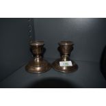 A pair of HM silver candlesticks of plain squat form (AF)