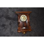 A wall mounted pendulum clock having enamel dial and mahogany styled case with chime