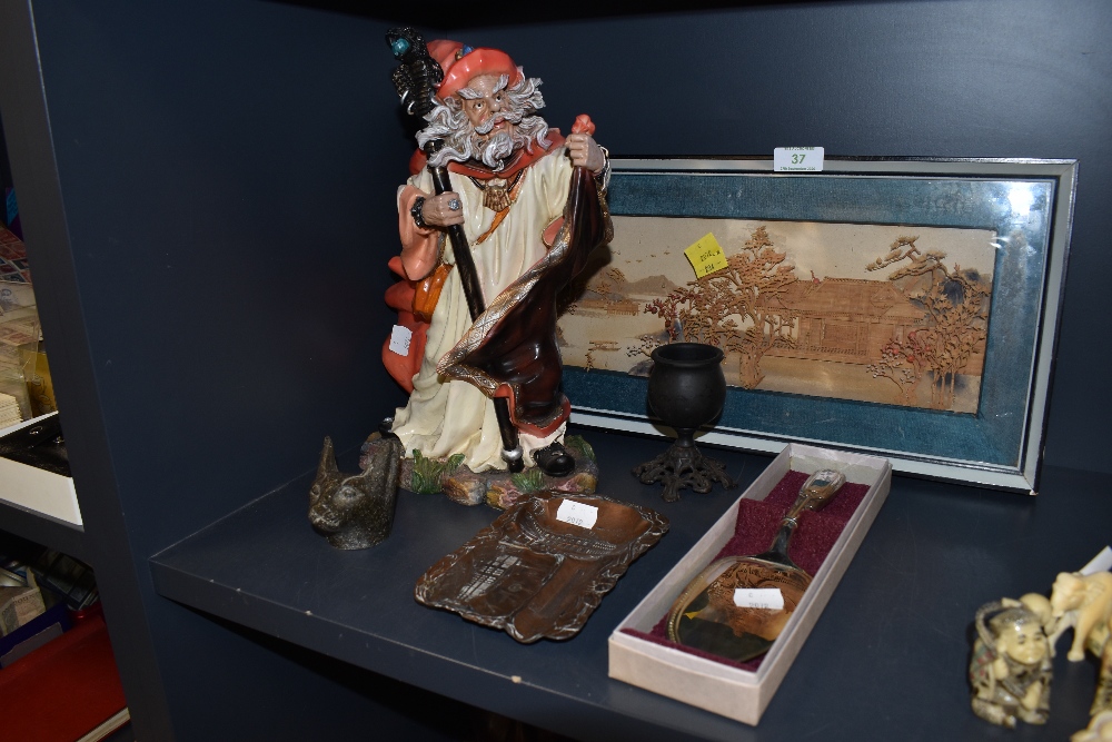 A selection of curios including Enchanted style Merlin figure and Chinese cork diorama