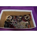A box of costume jewellery including bangles, bracelets and chains