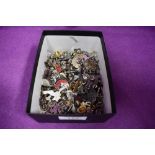 A large selection of pin badges, mainly animals and birds