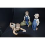 Three Royal Copenhagen Figures, Crawling Baby, model no 1739, length 15cm, Boy with Brush, model