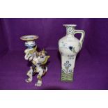 Two ceramics in Dutch designs including hand decorated figural dragon candle stick