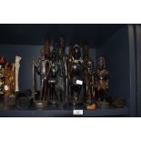 An selection of hand carved African tribal figures and totems including Ghana, Maasai and Zulu