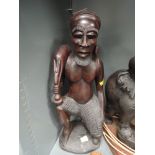 A large hand carved figure of an exotic hunter possibly Indonesian standing