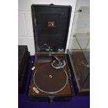 An antique gramophone shellac record player by HMV in good condition with arm winder