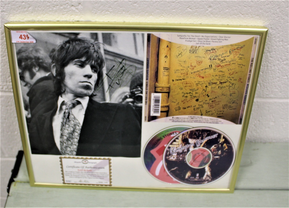 A framed and signed authenticated Keith Richards compact disc set and photo.