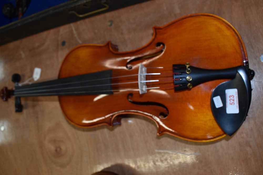 A traditional violin, labelled Piacenza
