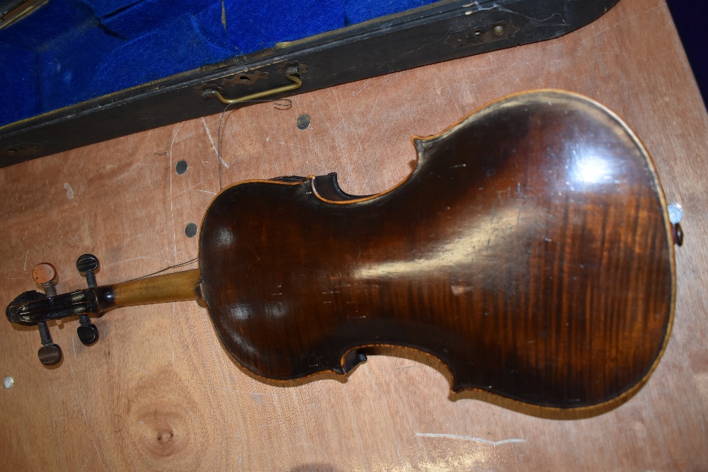 A distressed dark stained 19th Century violin having lion mask scroll, on piece back and traditional - Image 2 of 3