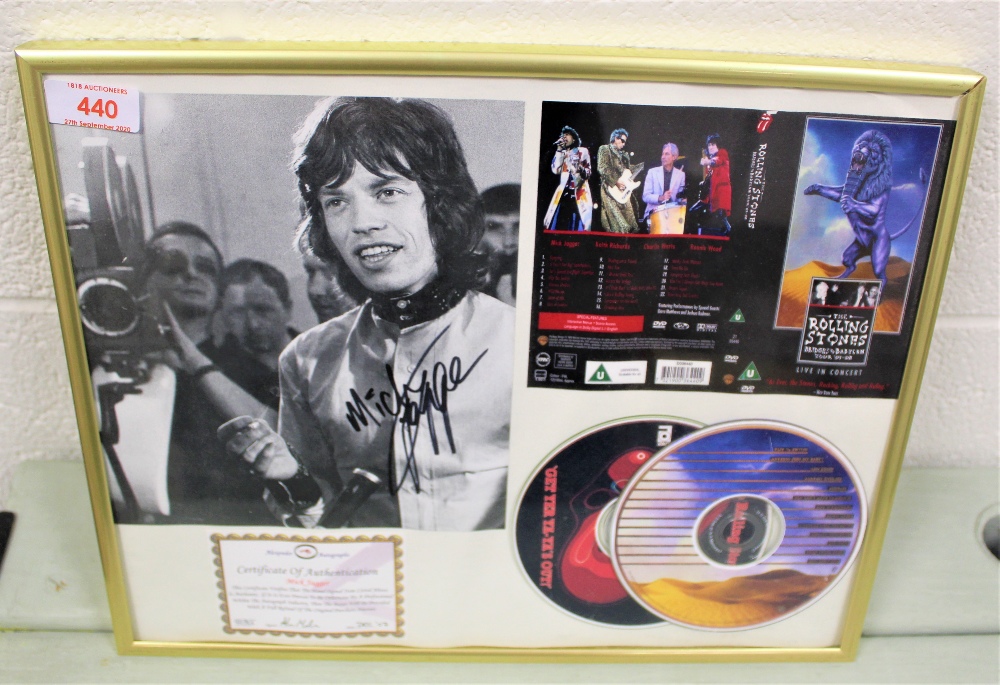 A framed and signed authenticated Mick Jagger compact disc set and photo.