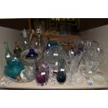 A large assortment of glass amongst which are some colourful pieces, vases,rose bowls, decanters and
