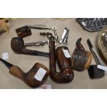 An assortment of vintage pipes having wooden bowls, an inlaid snuff box, a pen knife and more.