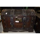 A small wooden retro chest with handles to sides, straps and lock to front.
