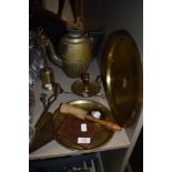 A mixed lot of brass, fire side utensils, two embossed platters a candlestick holder and more,