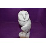 A figure of an owl by Beswick in a bisque ceramic and stamped to base