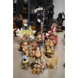 A collection of Goebel figurines, two Royal Doulton figurines and more.