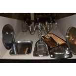 A lot containing a selection of stainless steel trays, toast rack,serving platters and vintage