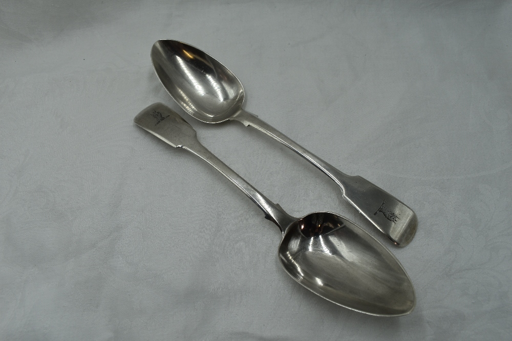 A pair of Georgian silver tablespoons fiddle back form bearing Griffin crest to terminals, Exeter