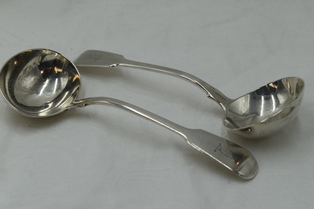 A pair of Georgian silver sauce ladles of fiddle back form bearing griffin crest to terminals,