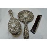 A silver three piece dressing table set having mask bird and scroll moulded decoration, Birmingham