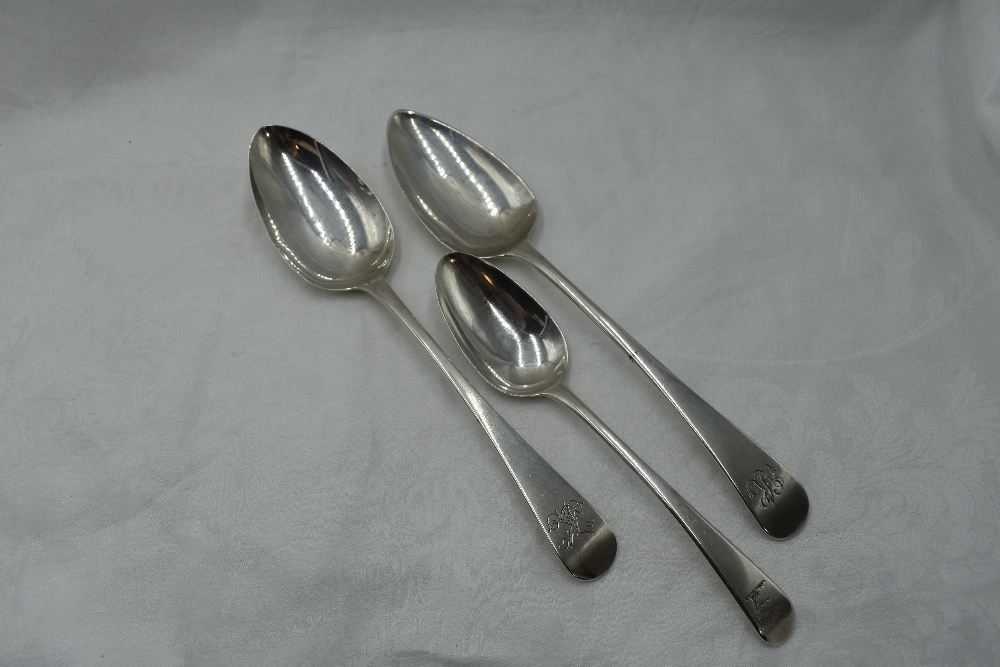 Two Georgian table spoons of Old English form bearing monogram to terminals, London 1803/17,