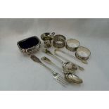 A selection of HM silver including napkin rings, miniature tankard, salt with blue glass liner, a