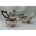 An Art Deco style silver three piece breakfast set of plain elongated hexagonal form having hard