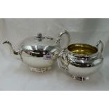 A Victorian silver teapot of plain compressed circular form having melon and leaf knop and