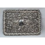 An Edwardian silver dressing table tray of rectangular form having embossed mask, scroll and bird