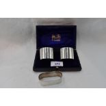 A cased pair of silver napkin rings of plain form bearing monogram A, Chester 1925, Barker Brothers,